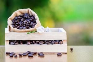 Coffee in wooden box with green blurred background photo