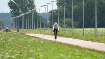 Cyclist in training, bike path near Polderbann runway video