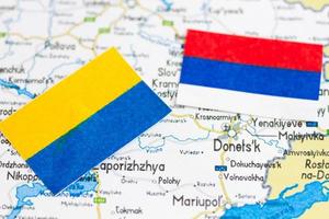 Ukraine and Russia Flags Above Ukraine Map photo