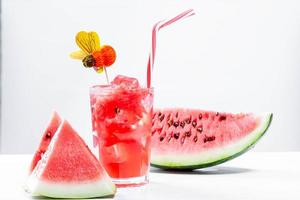 Watermelon drink in glass with slices of watermelon photo