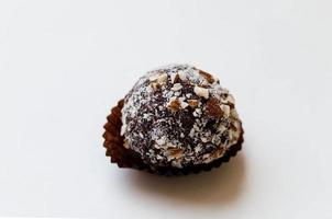 dark chocolate truffle with cocoa powder and chopped hazelnut