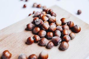 Close up of hazelnuts on board. White background photo