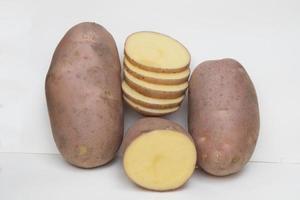 Potato Raw Vegetable isolated on Grey Background. Slice potato photo