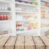 wood counter with blur shelves of drug in the pharmacy photo