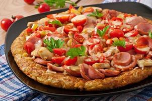 Potato gratin - pizza with sausage, mushrooms and tomatoes photo