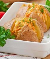 Baked potatoes stuffed with minced chicken and carrots photo