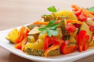 Roasted vegetables - zucchini, tomatoes, carrots, onions and paprika photo