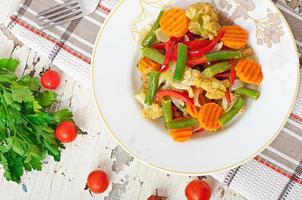 Steamed vegetables - cauliflower, green beans, carrots and onions photo