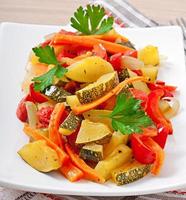 Roasted vegetables - zucchini, tomatoes, carrots, onions and paprika photo