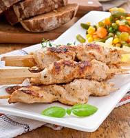 grilled chicken on bamboo skewers photo