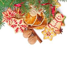 Christmas cookies, spices and spruce branches isolated on white background photo