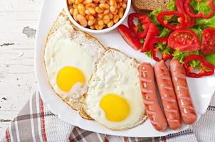 English breakfast - sausages, eggs, beans and salad photo