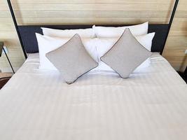 white bedsheet prepare on bed room. with pillow. clean interior comfort service room in spa and hotel