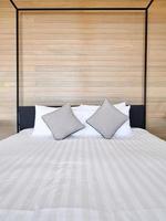 white bedsheet prepare on bed room. with pillow. clean interior comfort service room in spa and hotel photo