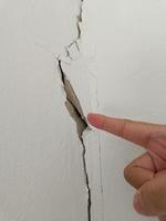 Area index finger cracks on the old white wall photo