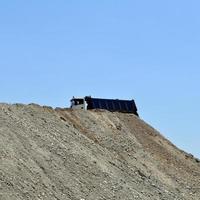 Truck on top of an earth mound photo