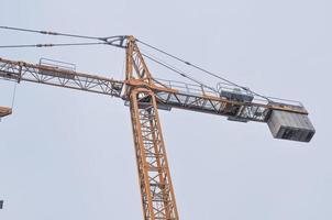 Building crane in a construction site over blue sky photo