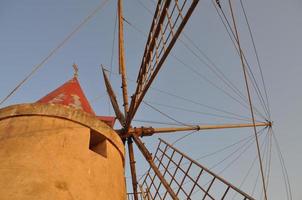 Windmill at saline Salt flats in Marsala photo