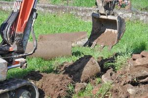 Excavator digging a hole photo