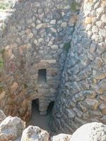 Ruins of ancient Sunuxi Nuraghe megalithic building in Sardinia, photo
