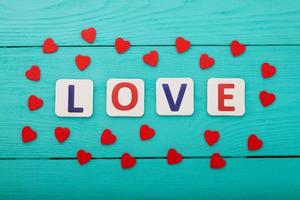 Word love on blue wooden background. Top view photo