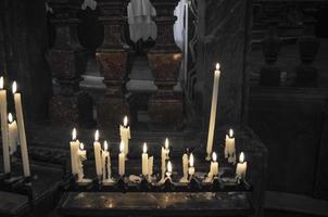 lit candles in a church photo