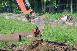 Excavator digging a hole photo