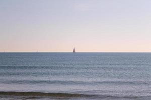 View of the sea with sails on the horizon photo