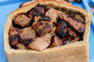 Grilled meat in a loaf of bread, close up