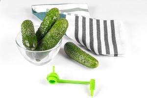 Fresh cucumbers and vegetable spiral cutter photo