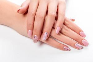Well-groomed female hands with manicure on a white background