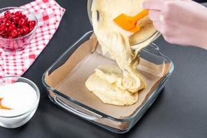 The dough is poured into a glass baking sheet photo