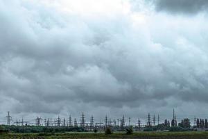 High-voltage power lines with sky background. Electricity distribution station
