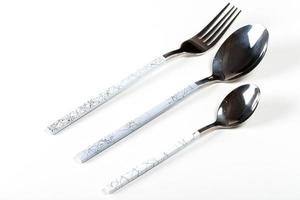 Spoon, fork and teaspoon on white background