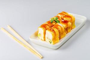 Set of sweet rolls with cheese and fruit on a white background with chopsticks