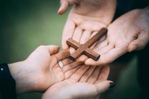 mano con cruz. concepto de esperanza, fe, cristianismo, religión, iglesia en línea. foto