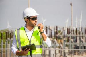 engineer team working in wind turbine farm. Renewable energy with wind generator by alternative energy concept. photo