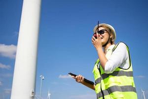 engineer team working in wind turbine farm. Renewable energy with wind generator by alternative energy concept. photo