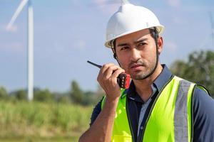 engineer team working in wind turbine farm. Renewable energy with wind generator by alternative energy concept. photo