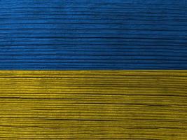 Ukrainian flag painted. Wrinkled blue and yellow colored grungy background photo