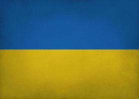 Ukrainian flag blue and yellow colored old paper background with vignette and copyspace photo