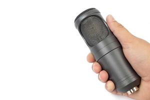Brand new black studio condenser microphone in the hand with copy space