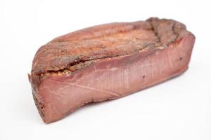 Whole piece of Smoked Ham isolated above white background photo
