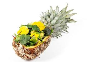 Pineapple stuffed with mix of different lettuce leaves and edible flowers