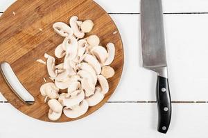 Chopped Mushrooms on the round wooden cutting board
