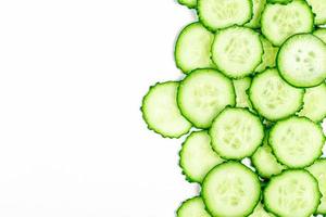 Round cucumber slices on a white background with free space