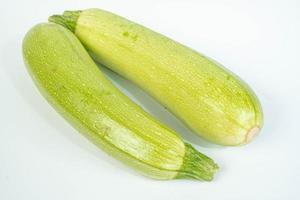Green Zucchini above white background photo