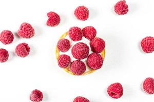Top view, cake with whipped cream and raspberries on a white background photo