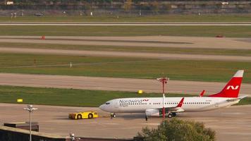 Boeing 737 airliner being towed before departure. video