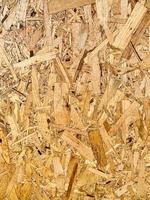 Compressed chipboard background. Wooden plank backdrop. OSB texture photo